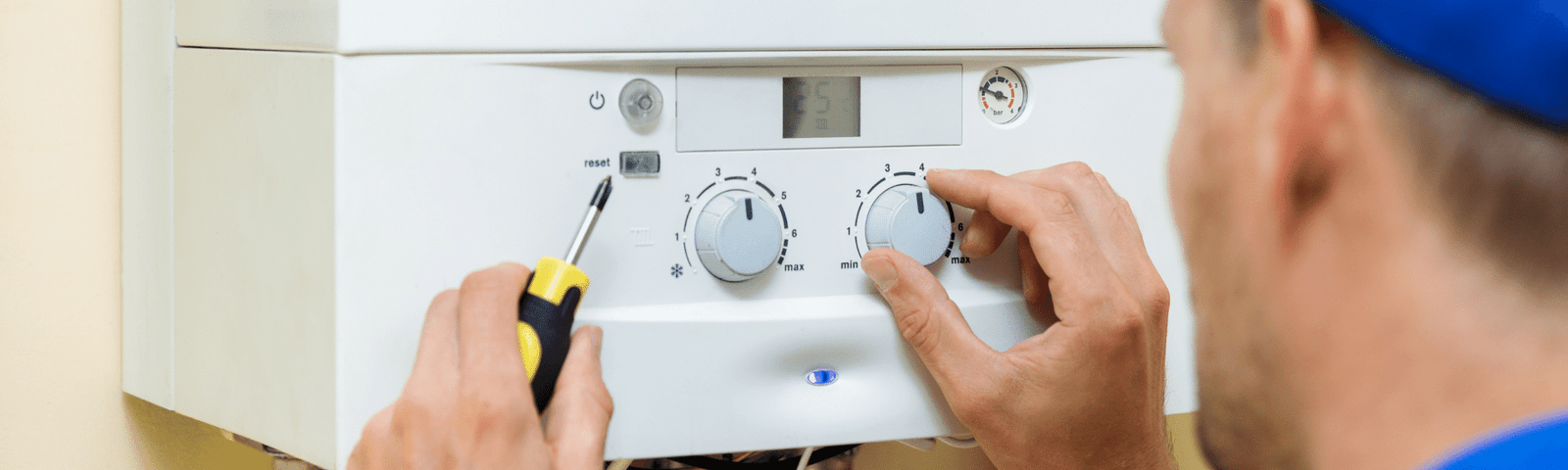 image showing a man fixing a boiler
